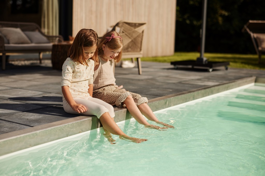 houten accommdatie zwembad met meisjes voeten in het water